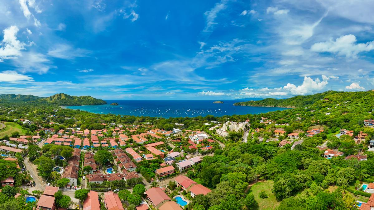Aerial panoramic view of Playas del Coco's bay, marina, and neighborhoods