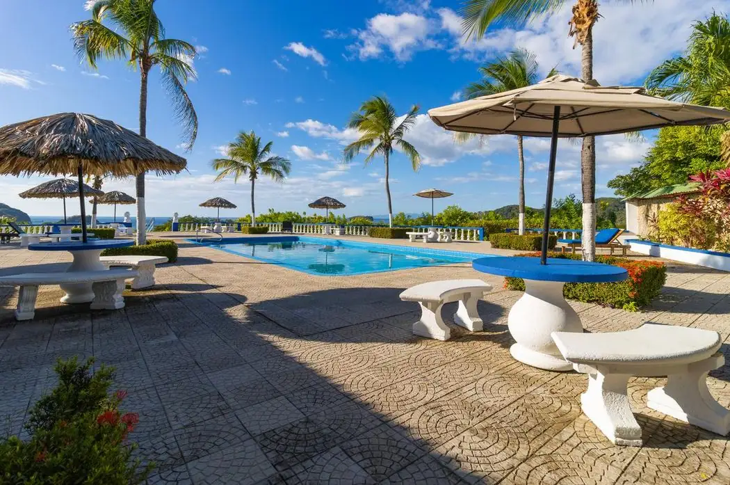 Pool deck with ocean view at a Tucanes condo in Playas del Coco